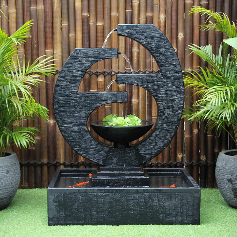 Galleria Imports New Eclipse Fountain Medium in Chrcoal Front Viewi in the garden