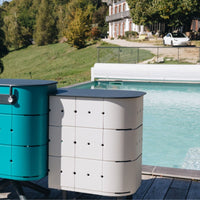 Aluvy Jean Basalt Outdoor Storage Cabinet in Champagne and aqua beside the pool