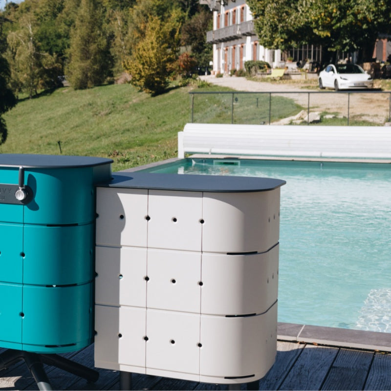 Aluvy Jean Basalt Outdoor Storage Cabinet in Champagne and aqua beside the pool