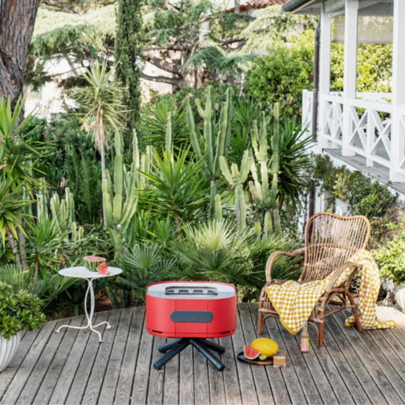ALUVY SAM Low Brazier Piment outdoor full view with Cactus background and chair beside