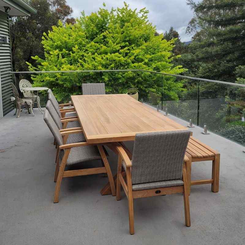 East India Teak Alexander Cross Leg Table with Flinders Wicker chairs on a balcony