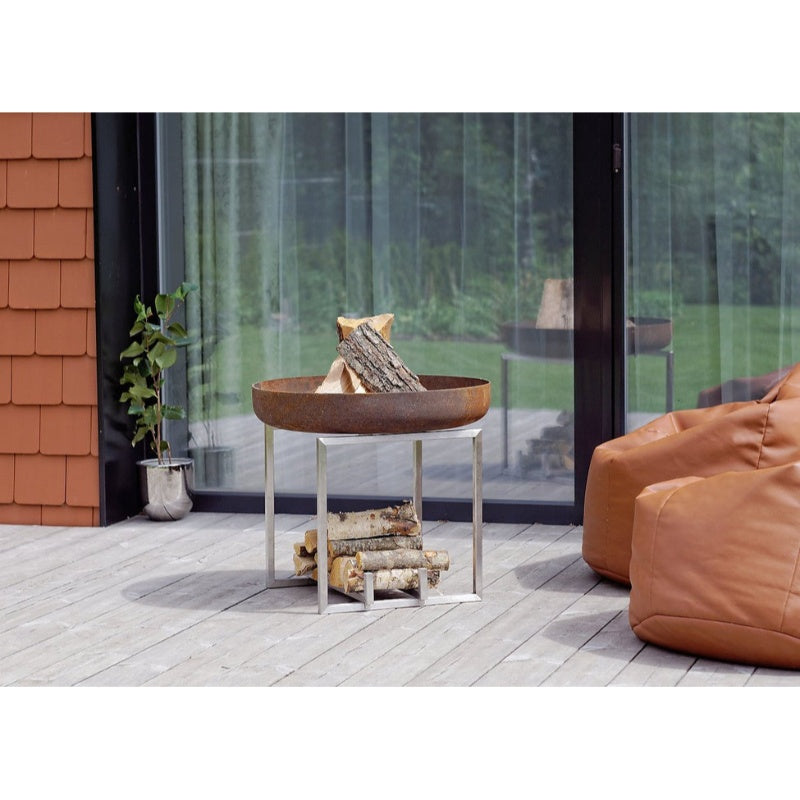 Alfred-Riess Hekla Steel Fire Pit Medium on Deck glass door behind