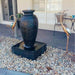 Amphora Fountain Charcoal with rocks in front of the house