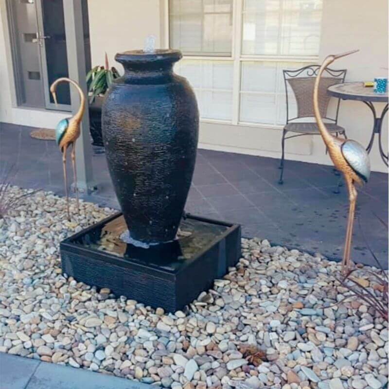 Amphora Fountain Charcoal with rocks in front of the house