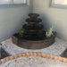 Corner Bowl Fountain Rust with plants surround
