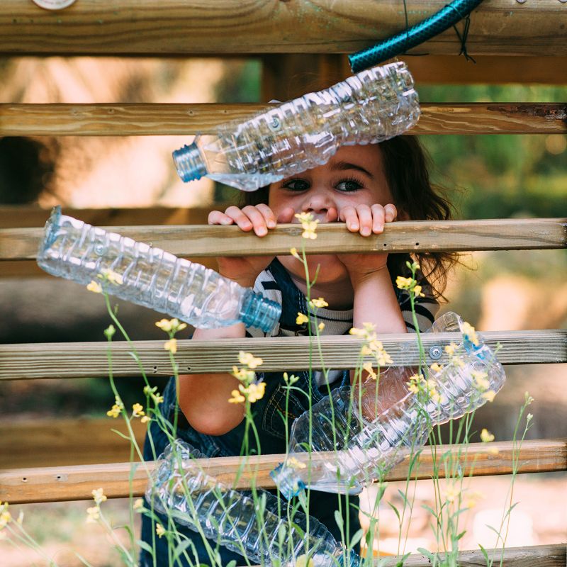 Discovery Woodland Treehouse bottles attached to the treehouse and girl at the back
