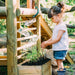 Discovery Woodland Treehouse girl planting on the side