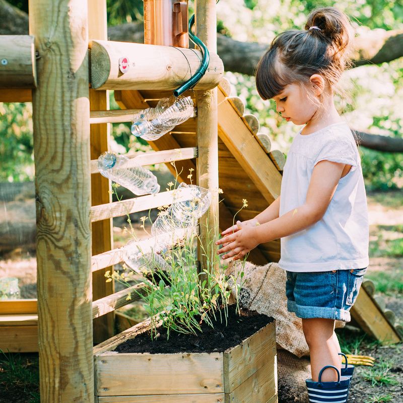 Discovery Woodland Treehouse girl planting on the side