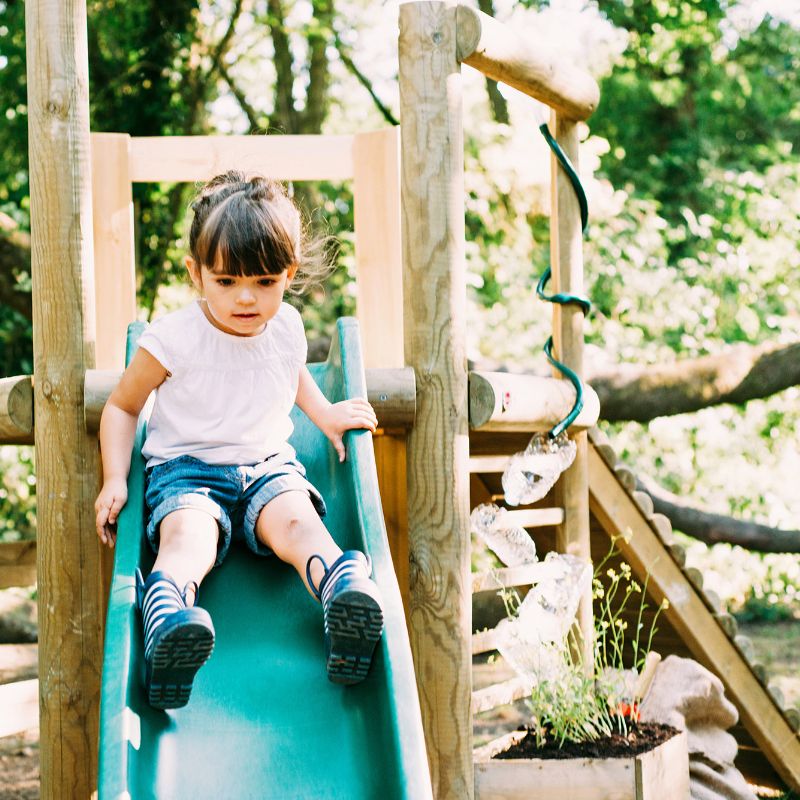 Discovery Woodland Treehouse girl on slide