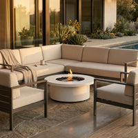 ExcoSmart Fire Table in Bone in alfresco area with sofa, chairs and by the pool and garden