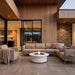 ExcoSmart Fire Table in Bone on the patio by the sofa