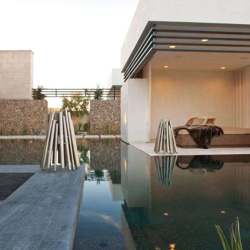 Ecosmart fire stix stainless steel with stainless burner beside the pool