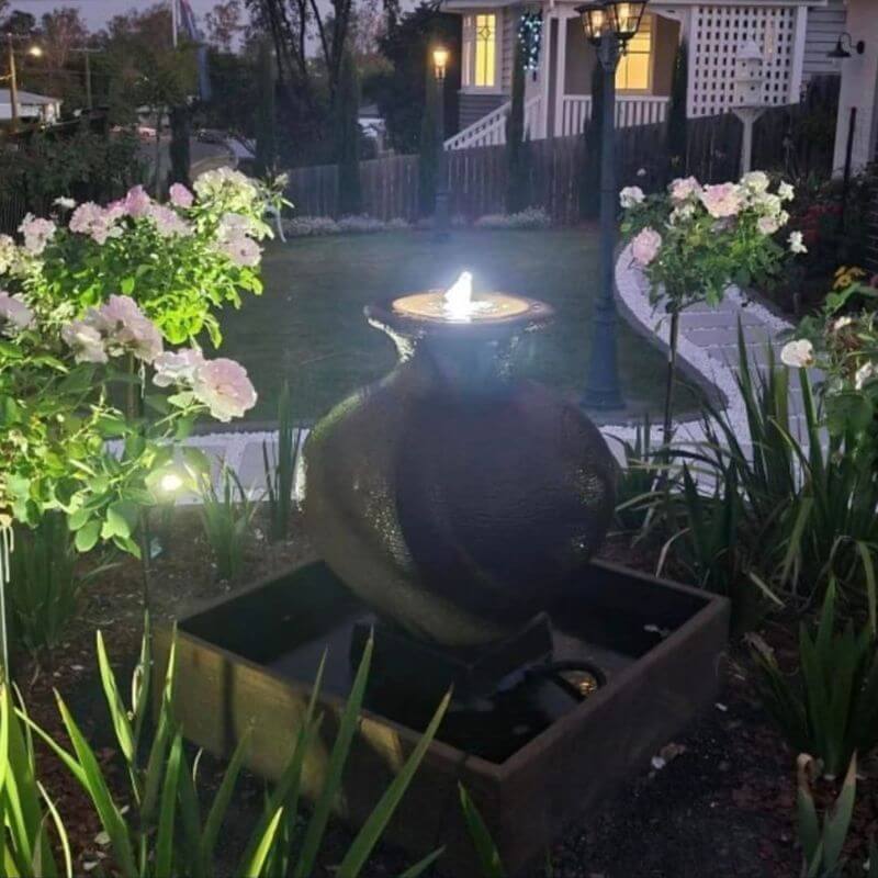 Florentine Fountain Rust garden with lights at night