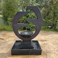 Galleria Imports New Eclipse Fountain in Charcoal placed in the backyard