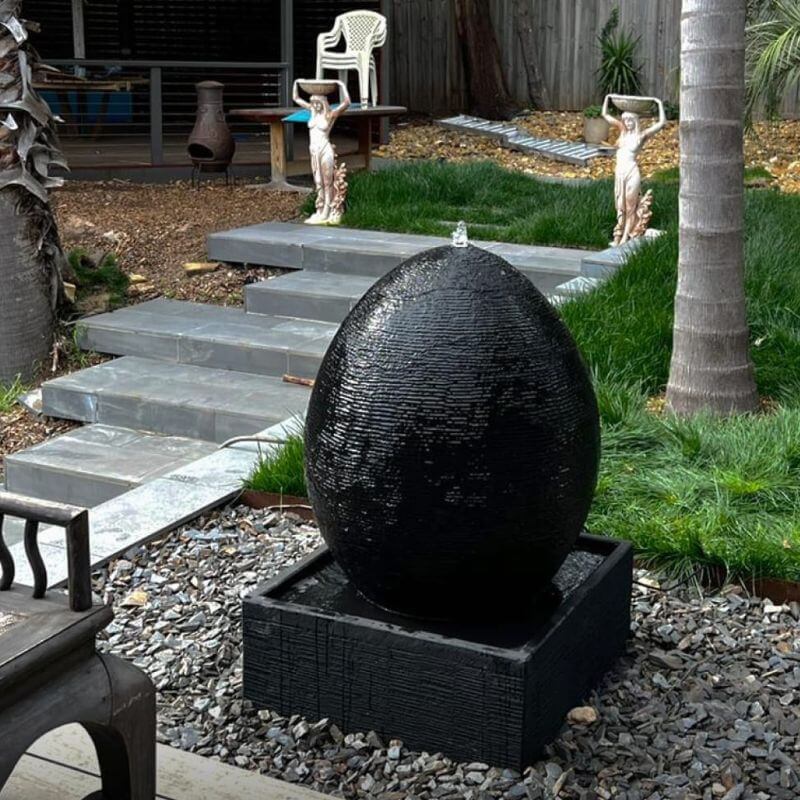 Galleria Imports Egg Fountain Charcoal with rocks surround