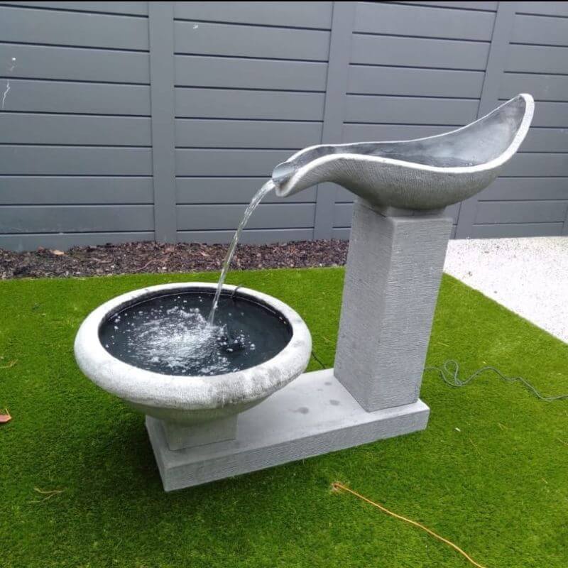 Galleria Imports Single Wave Fountain White Lifestyle at the front yard