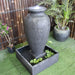 Grey Galleria Amphora water fountain from top left angle into pond