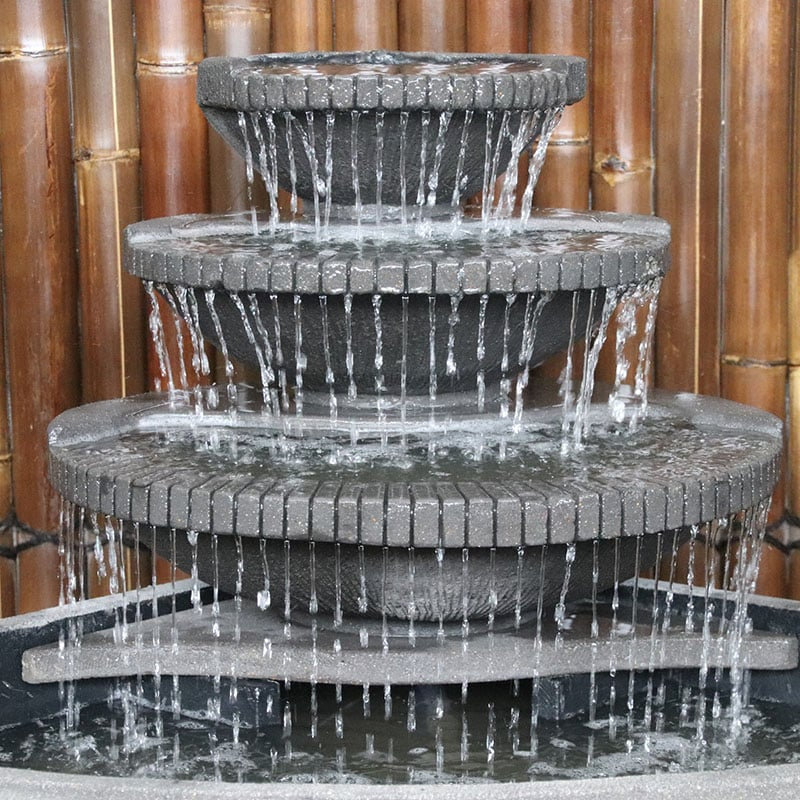 Grey corner bowl fountain by Galleria Imports close up of streaming water
