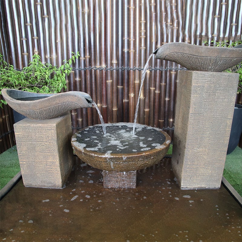 Double Wave fountain by Galleria  in Rust close up of top water streaming into pool