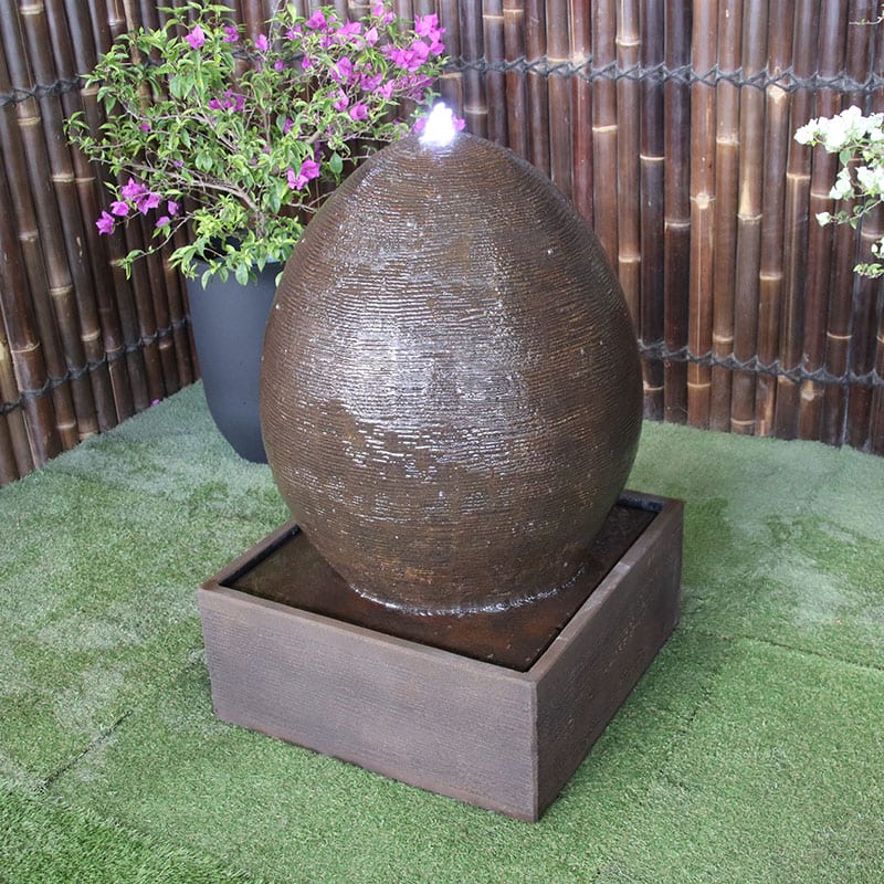 Egg fountain in rust by Galleria Imports top right angle view
