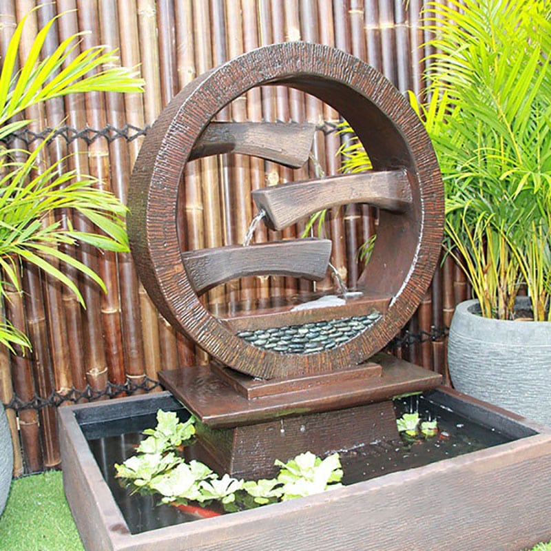 Galleria Imports Wagon Wheel Fountain medium in rust left angle close up