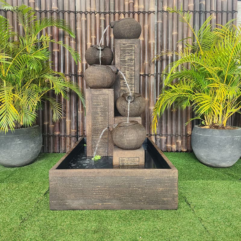 Streaming Pots Fountain by Galleria Imports in large rust front view in the garden