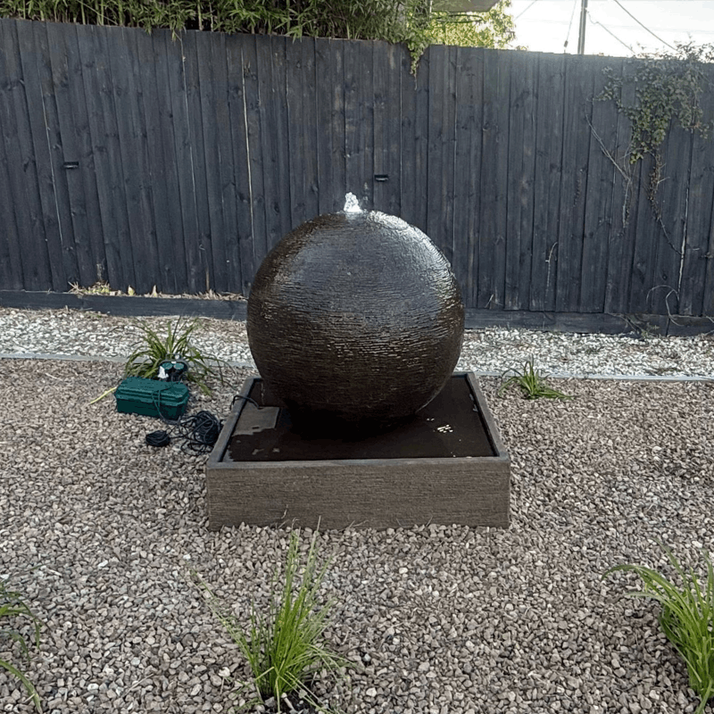 Large Luna Ball in Rust with crushed rocks and wooden fence