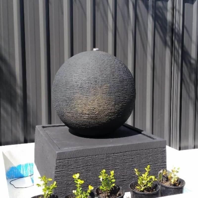Small Luna Ball Fountain in Grey  with grey wall fence