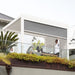 Luxi Living Baltic Manual Freestanding Louvre Roof Aluminium Pergola -Man in shades under a pergola