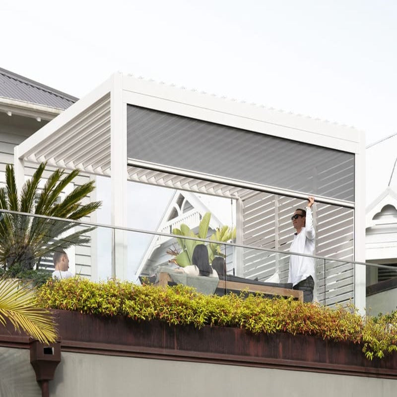 Luxi Living Baltic Manual Freestanding Louvre Roof Aluminium Pergola -Man in shades under a pergola