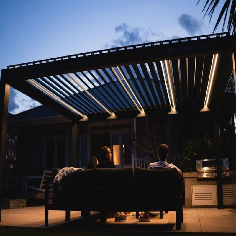 Luxi Living Baltic Motorised Freestanding Louvre Roof Aluminium Pergola - people underneath pergola evening.