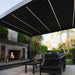 Luxi Living Baltic Motorised Freestanding Louvre Roof Aluminium Pergola - fireplace underneath the pergola.