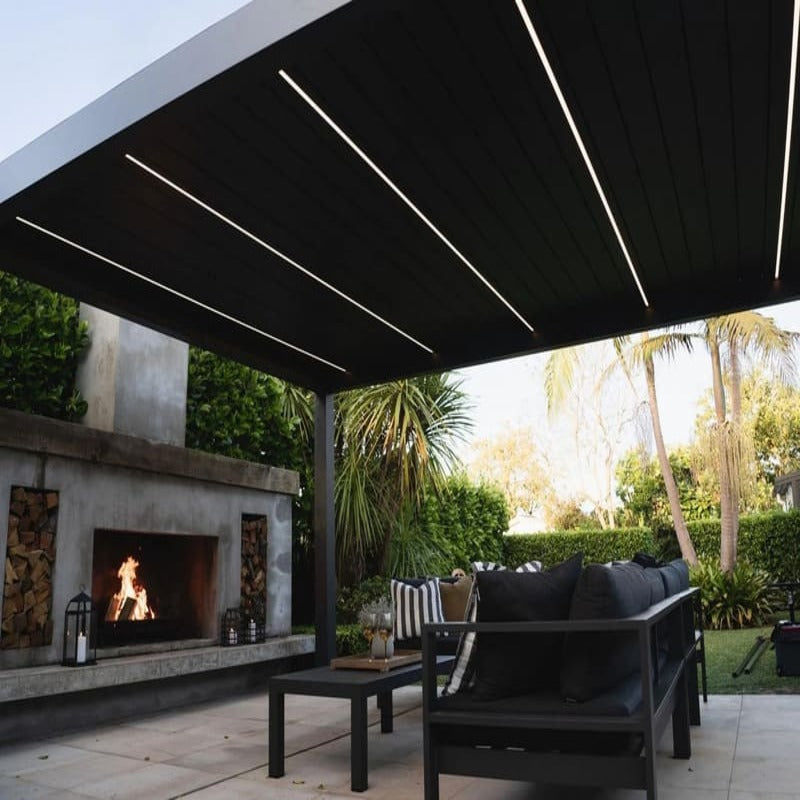 Luxi Living Baltic Motorised Freestanding Louvre Roof Aluminium Pergola - fireplace underneath the pergola.