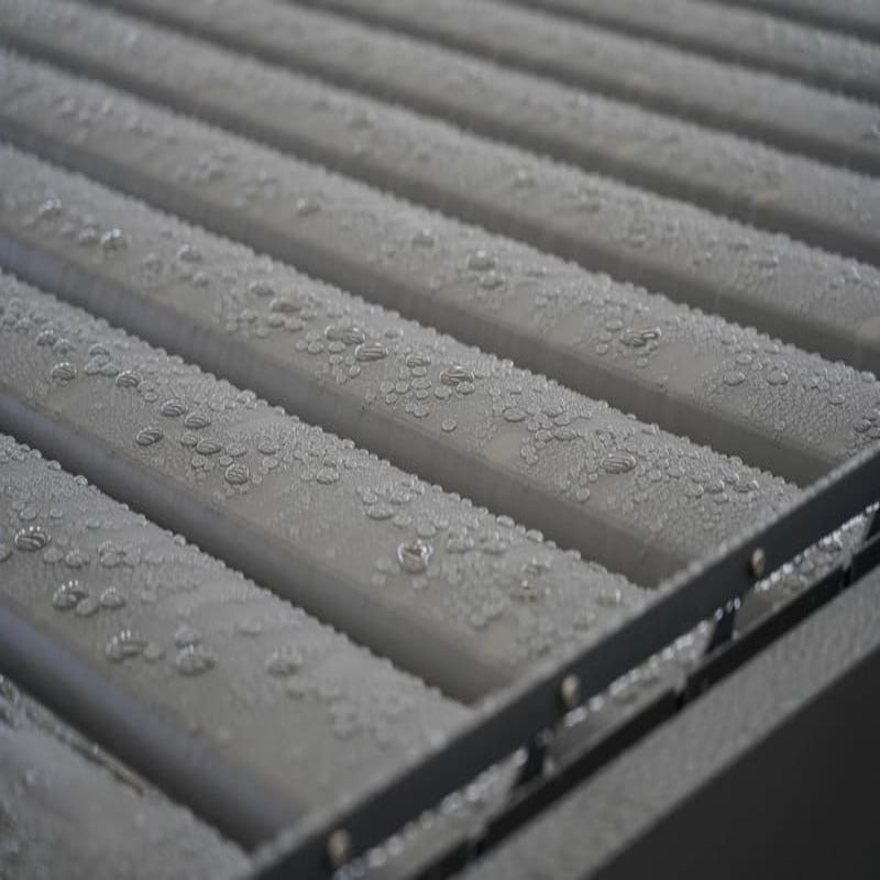 Luxi Living Baltic Motorised Freestanding Louvre Roof Aluminium Pergola - water droplets on a closed pergola.