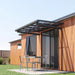 Luxi Living City Window / Door Awning Canopy setup against a wooden house