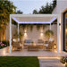 Luxi Living Pacific Motorised Freestanding Louvre Roof Aluminium Pergola - white pergola setup behind the house with lights on
