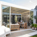 Luxi Living Tasman Motorised Freestanding Louvre Roof Aluminium Pergola-white pergola with Furniture setting inside