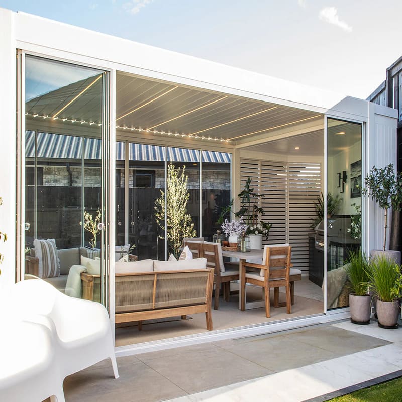 Luxi Living Tasman Motorised Freestanding Louvre Roof Aluminium Pergola-white pergola with Furniture setting inside