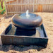Moon Pot Fountain Rust Lifestyle with sand surrounding