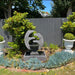 New Eclipse Fountain Medium Grey in Garden with wall fence