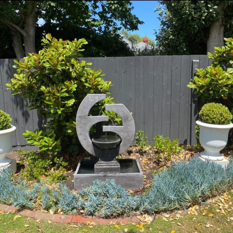 New Eclipse Fountain Medium Grey in Garden with wall fence