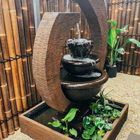 Original Eclipse Fountain Large Rust Lifestyle with floating plants sideview