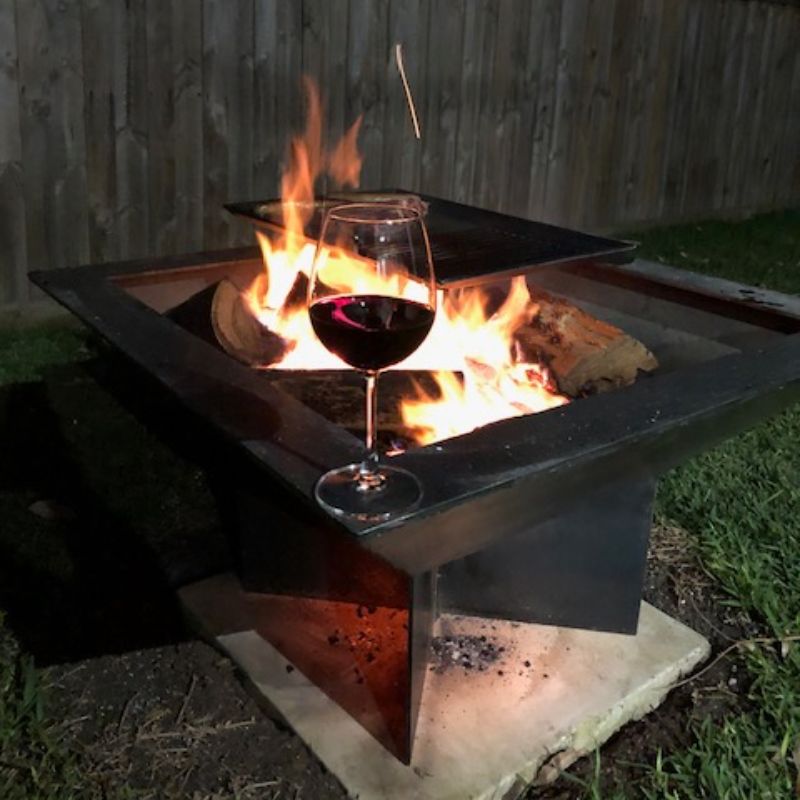 Pinnacle BBQ Firepit in the backyard with a glass of red wine