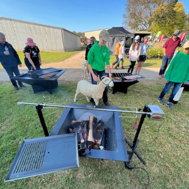 Pinnacle BBQ Firepit set up at the show with a hotplate and spit