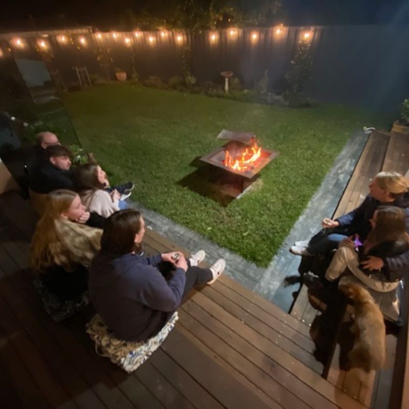 Pinnacle Fire pit in the backyard with friends gathered around