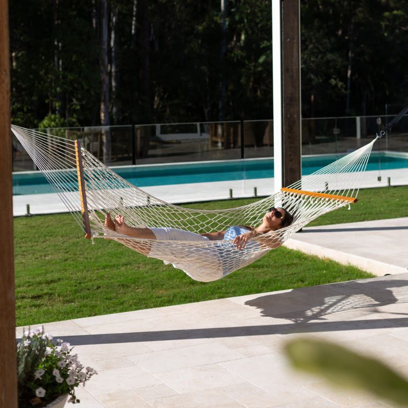 Resort King Polyester Rope Hammock Cream with person beside the Pool
