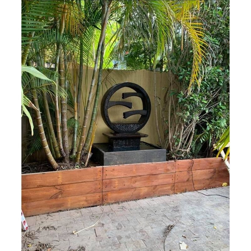 Wagon Wheel Fountain Large Charcoial with bamboo trees surround