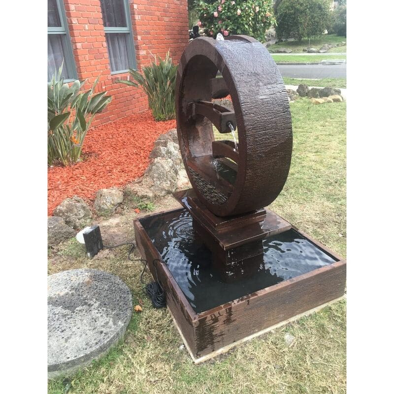 Wagon Wheel Fountain Large rust angle view at alwn area