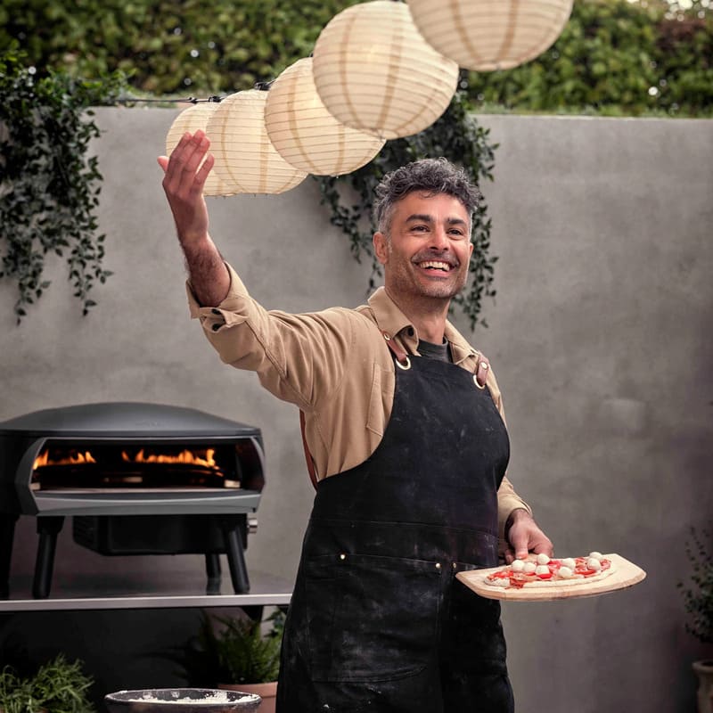 Witt Etna Rotante Gas Powered Pizza Oven with Twin Burner & Rotating Stone 16" - chef holding a mini pizza
