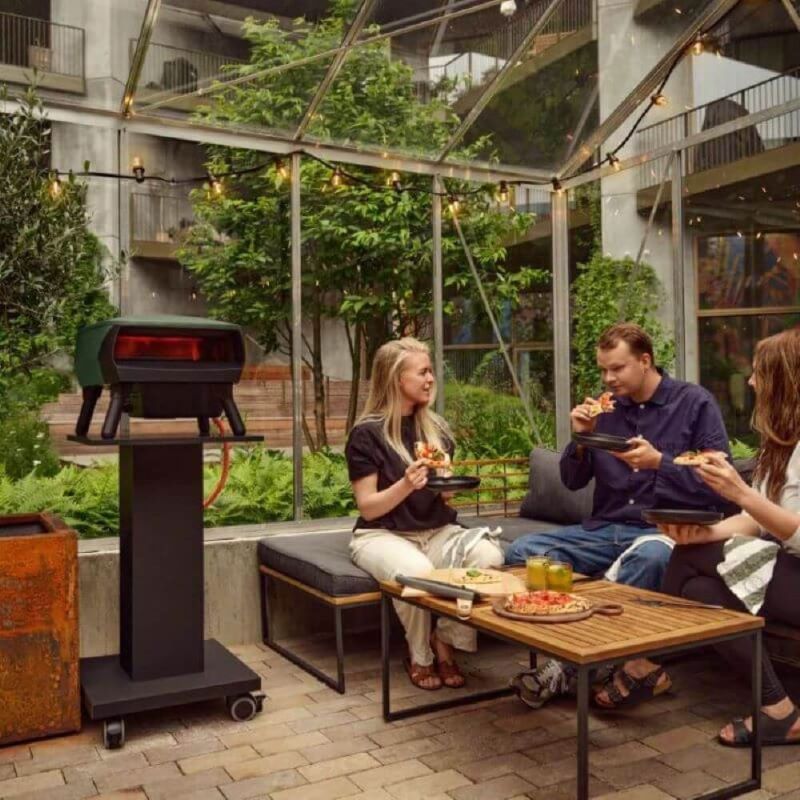Witt Piccolo pizza oven on patio with people eating pizza
